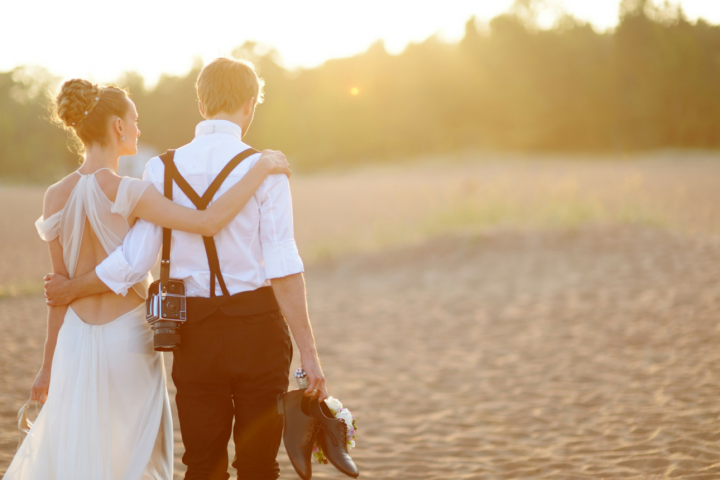 Bride and groom from behind at sunset
