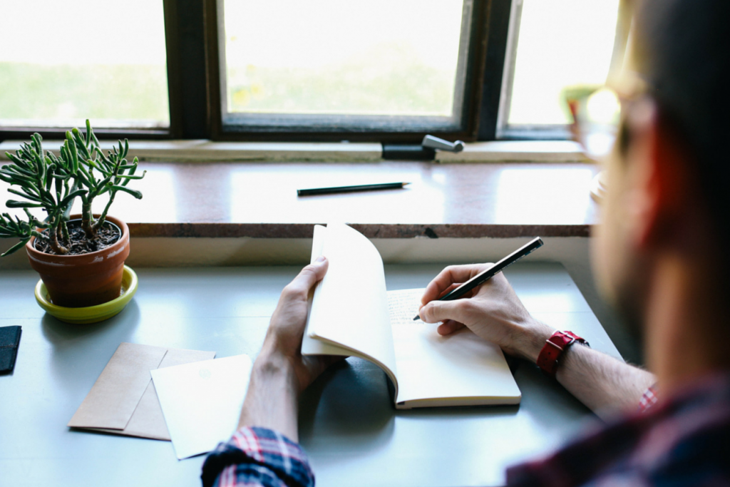 Man sketching content marketing for subscription businesses ideas at his desk