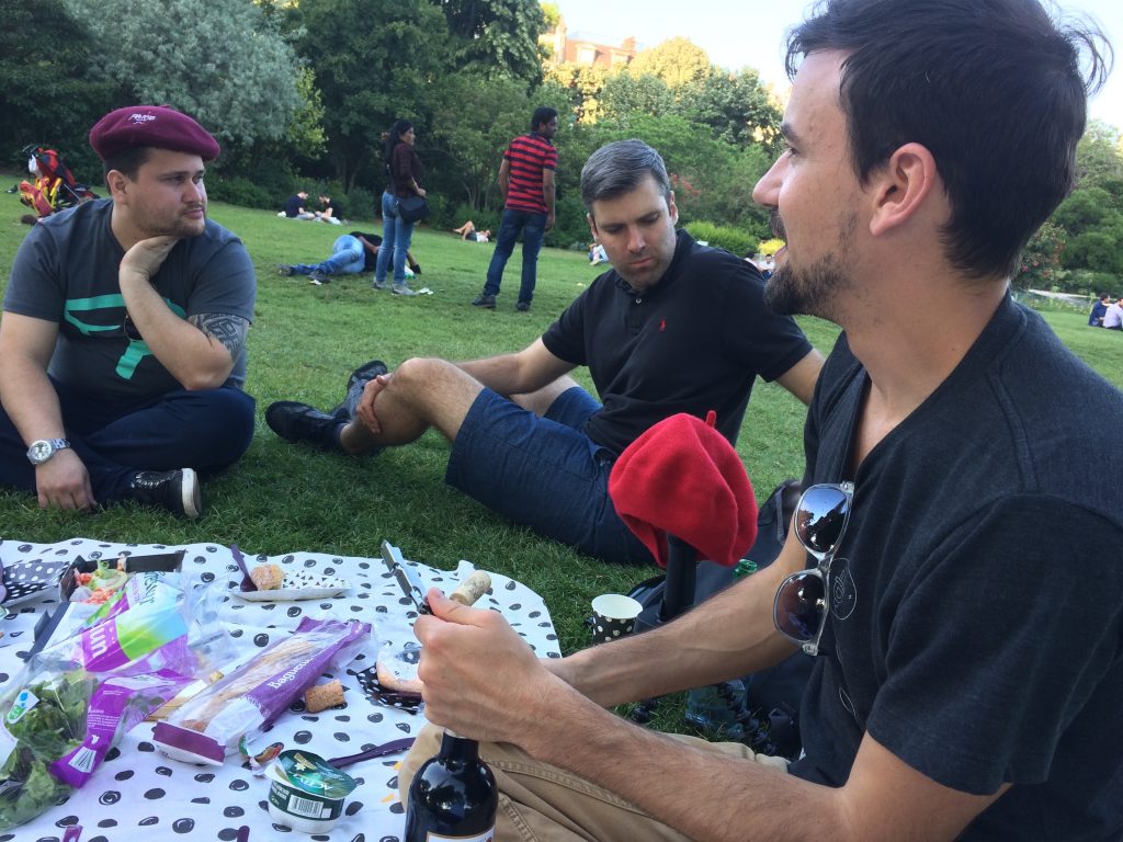 Three people having a picnic under the Eiffel Tower