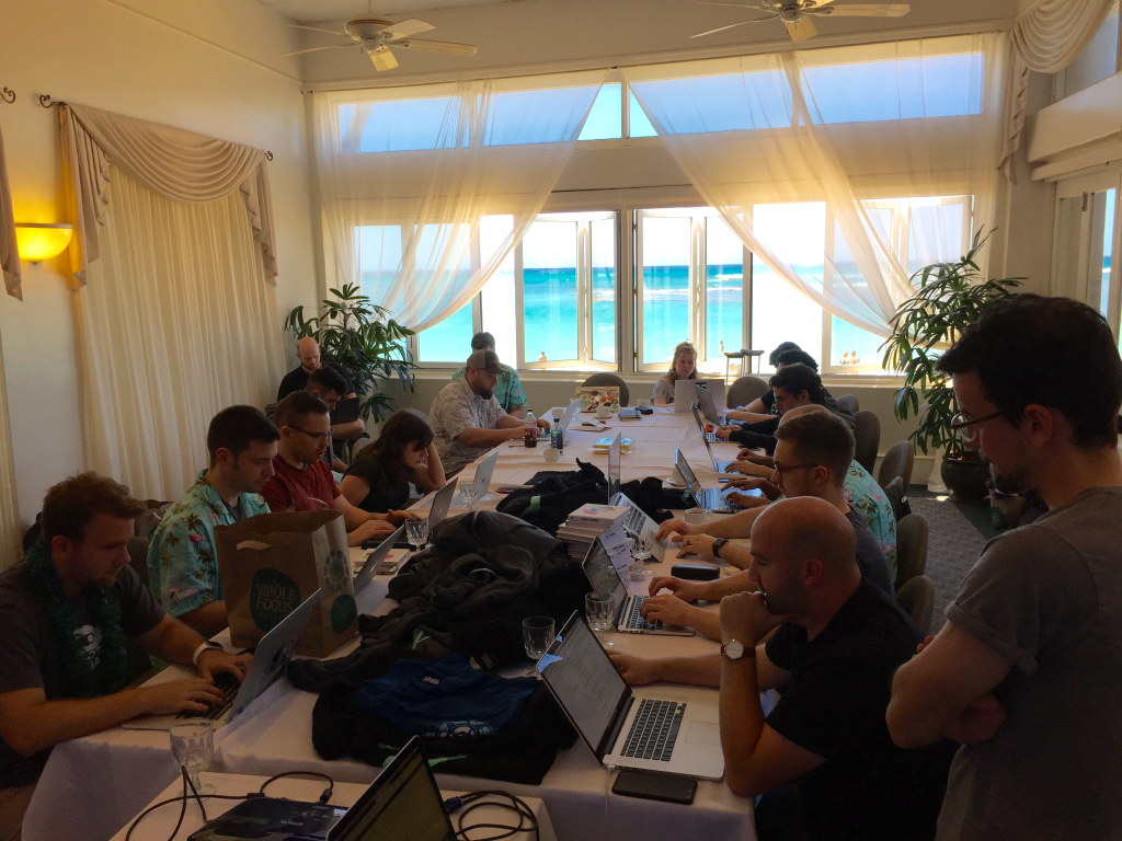 Prospress team sitting around a conference table looking at their laptops