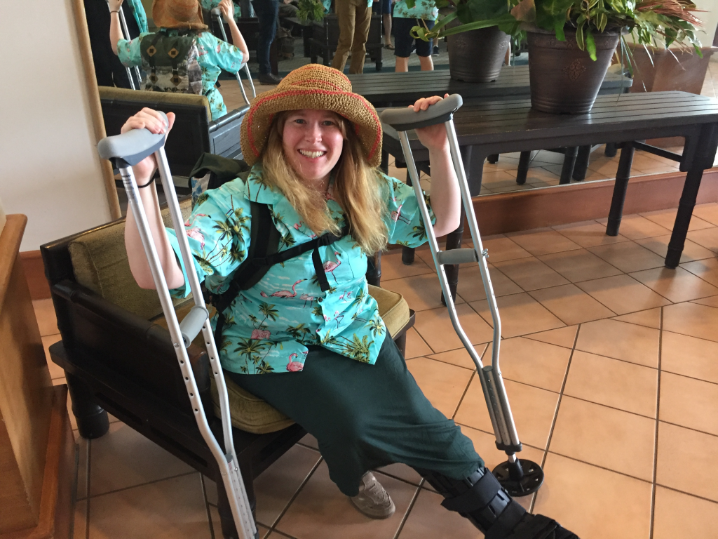 Woman sitting down holding crutches at Prosparadise