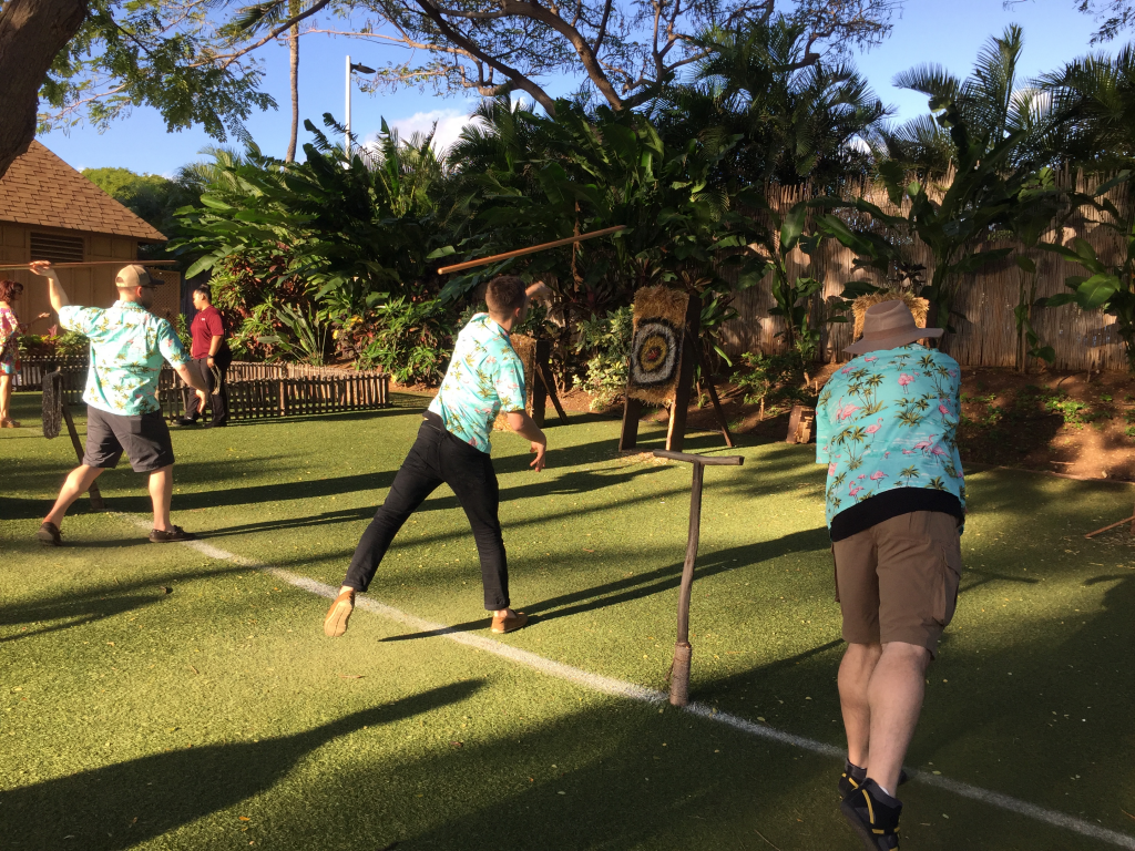 The team throwing spears at hay bales